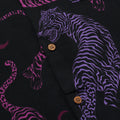 Close up photo of Blinky Bills Shirt No. 1 coconut shell buttons. Black short-sleeved shirt with print of purple and pink tiger tattoo designs.