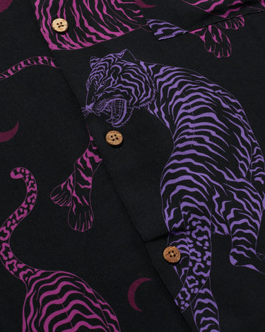 Close up photo of Blinky Bills Shirt No. 1 coconut shell buttons. Black short-sleeved shirt with print of purple and pink tiger tattoo designs.