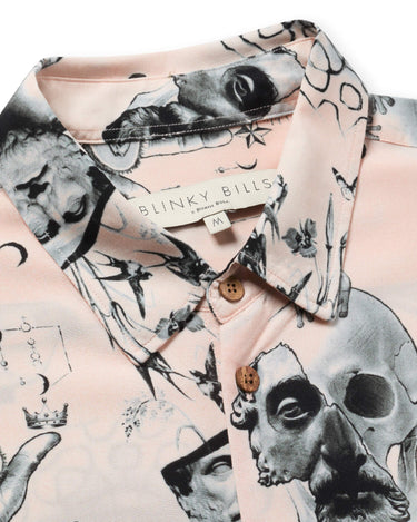 Close up photo of Blinky Bills Shirt No. 2 collar on white back ground. Very light pink short-sleeved shirt with print of different tattoo designs in greyscale.