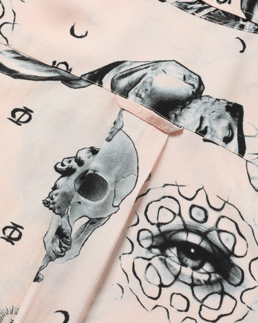 Close up photo of Blinky Bills Shirt No. 2 hook detail. Very light pink short-sleeved shirt with print of different tattoo designs in greyscale.