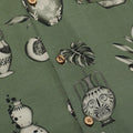 Close up photo of Blinky Bills Shirt No. 3 coconut shell buttons. Olive green short-sleeved shirt with print of tattoo designs of different vases.