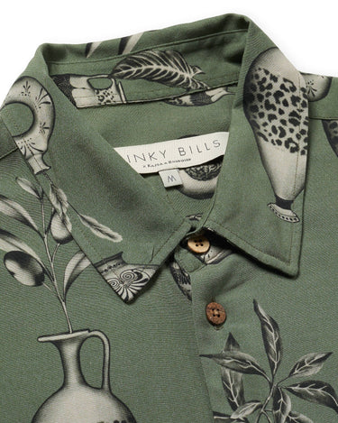 Close up photo of Blinky Bills Shirt No. 3 collar on white background. Olive green short-sleeved shirt with print of tattoo designs of different vases.